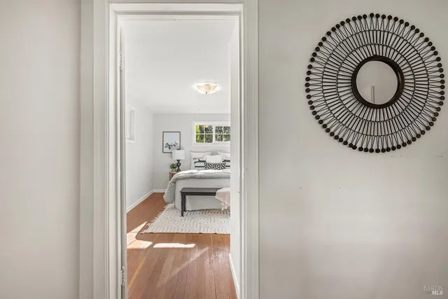 a view of a livingroom with wooden floor and a sink