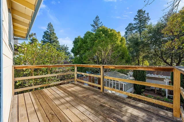 a view of balcony with wooden floor and fence