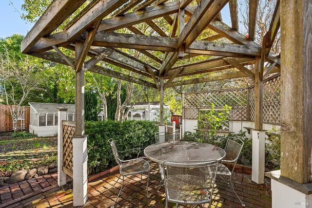 a view of a porch with furniture and a yard