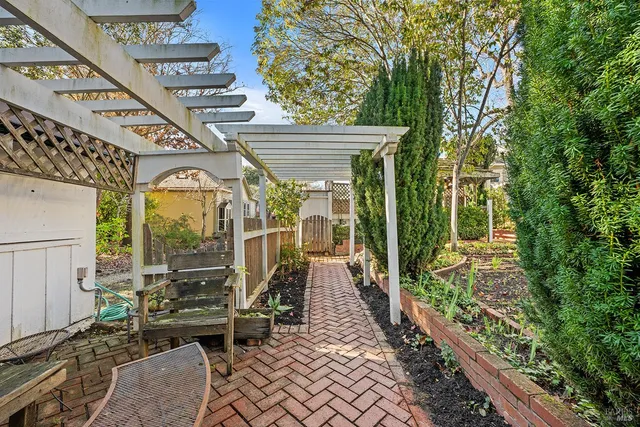 a view of a chairs and table in the patio with a backyard
