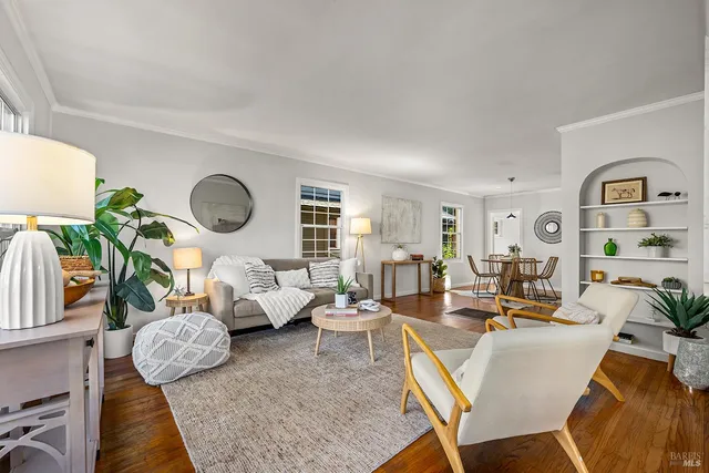 a living room with furniture and a mirror