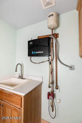 6233 West Airport Road Willcox, AZ 85643 - Photo 25 of 54 a bathroom with a sink and a mirror