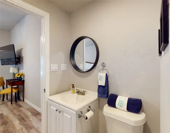 a bathroom with a toilet a sink and a mirror