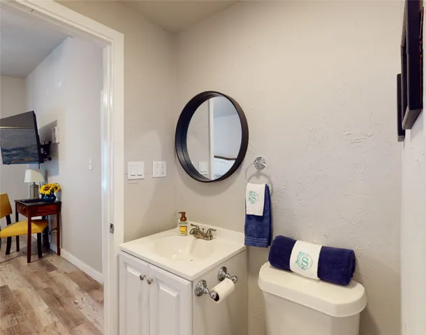 a bathroom with a toilet a sink and a mirror