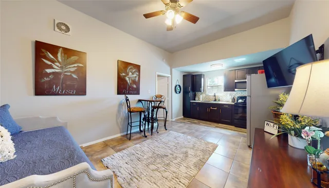 a living room with furniture and a dining table