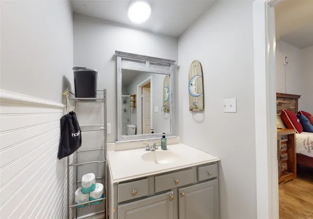 a bathroom with a toilet sink and mirror