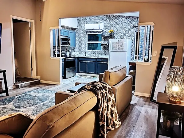 a kitchen with stainless steel appliances kitchen island a stove and a sink