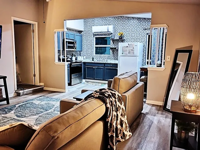 a kitchen with stainless steel appliances kitchen island a stove and a sink