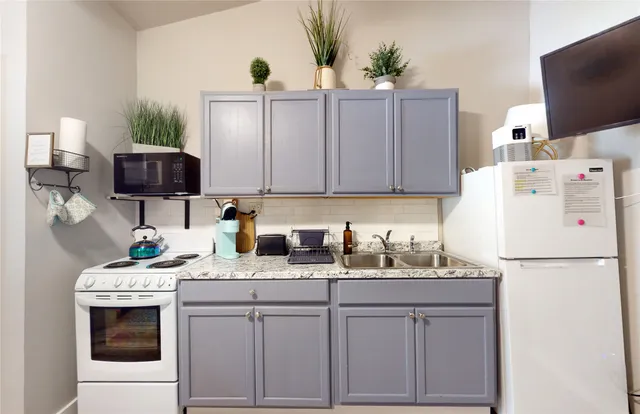 a kitchen with appliances a sink and a cabinets