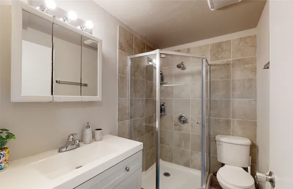 a bathroom with a sink toilet and shower