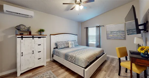 a bedroom with a bed and a chandelier