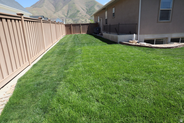 1055 North 1000 East Mapleton, UT 84664 - Photo 80 of 112 Expansive backyard featuring a lush lawn, privacy fencing, and a stucco exterior