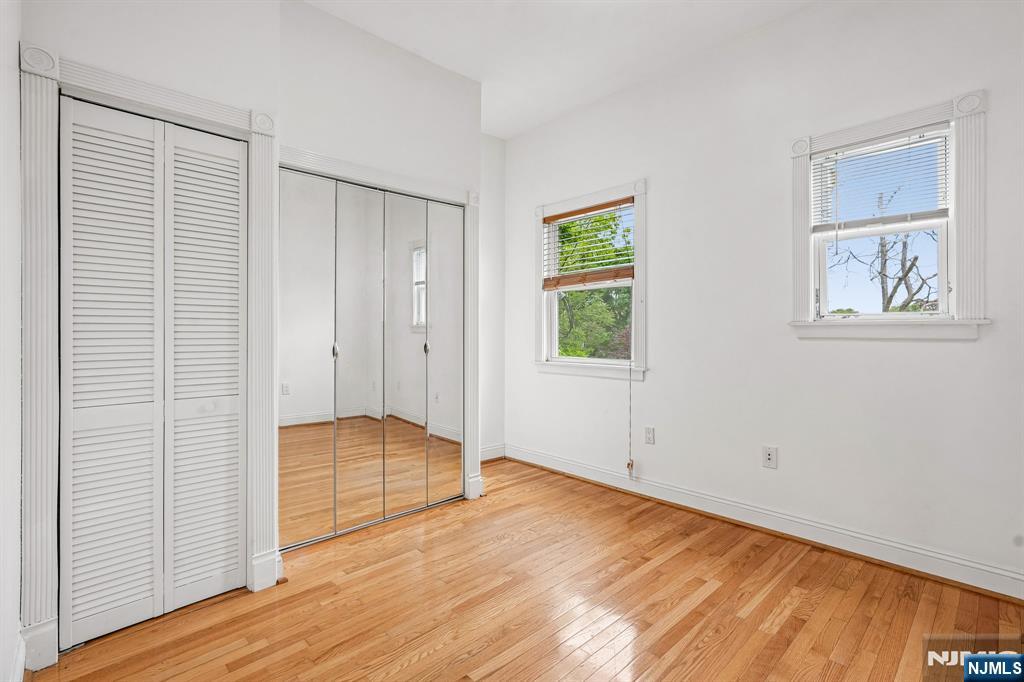 90 A Hackensack Plank Road Weehawken, NJ 07086 - Photo 27 of 40 an empty room with wooden floor and windows
