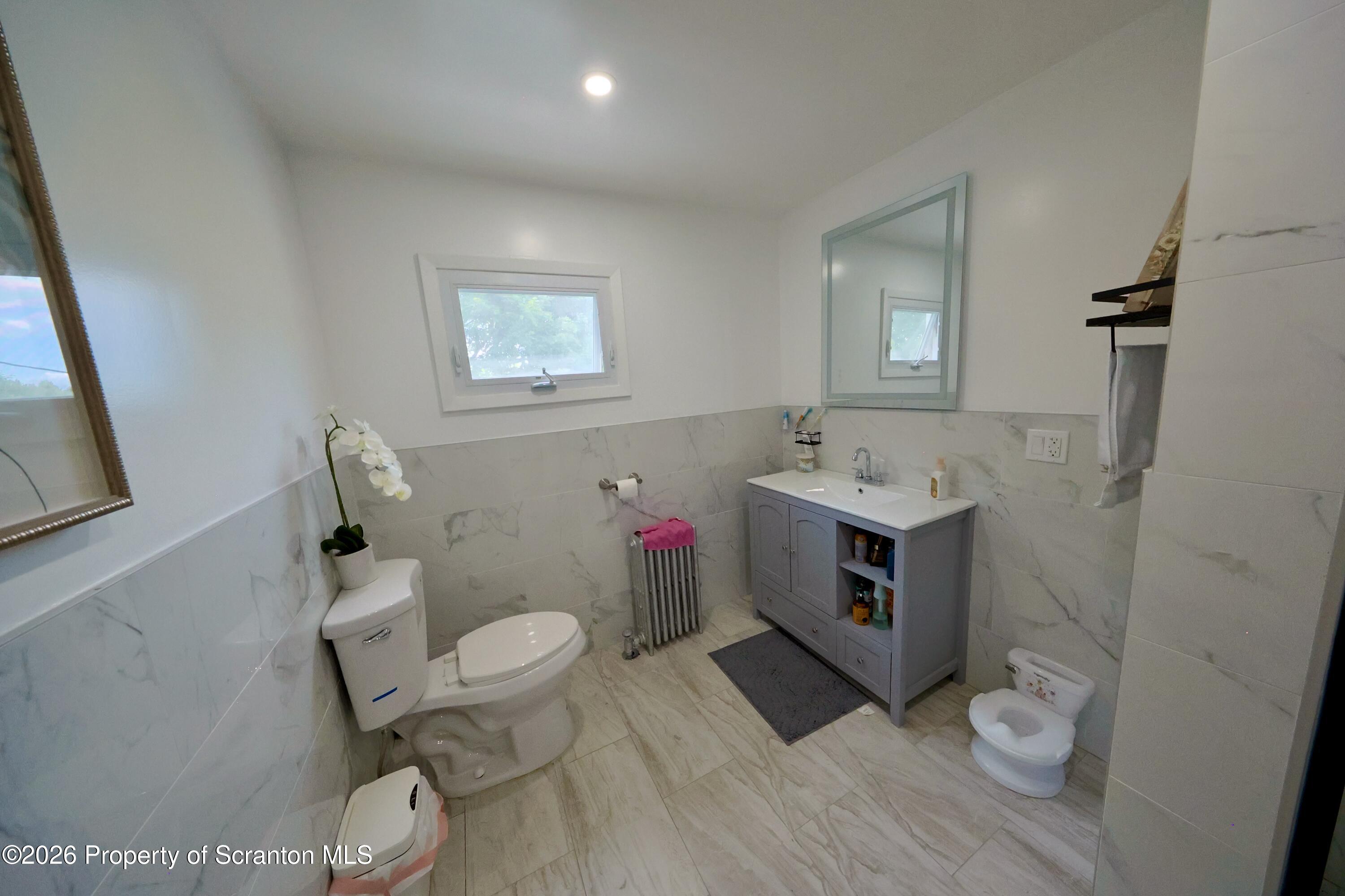 827 Main Street Sugar Notch, PA 18706 - Photo 11 of 25 a bathroom with a toilet sink and mirror