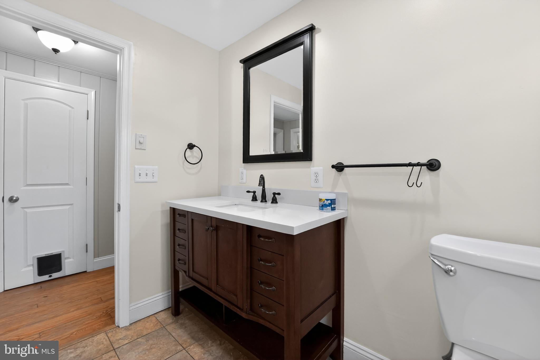 9408 Dana Vista Road Baltimore, MD 21236 - Photo 23 of 38 a bathroom with a sink vanity and a toilet