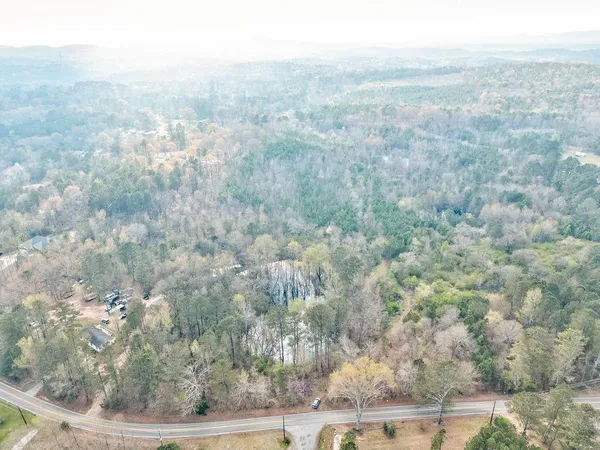 an aerial view of residential house and trees around