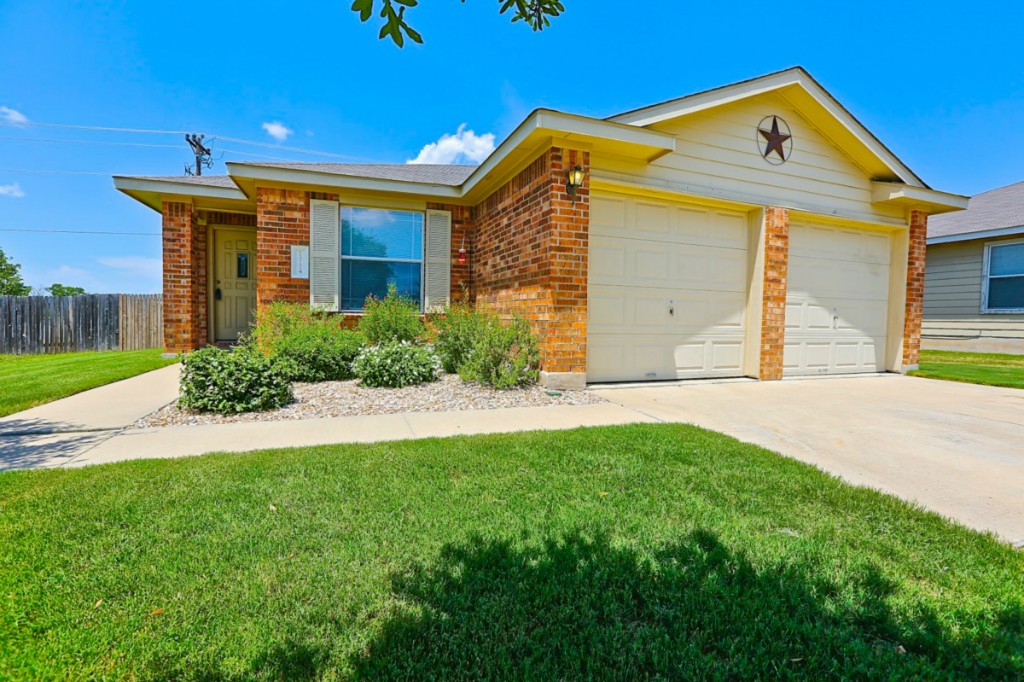 13124 Soap Winecup Mallow Trail Elgin, TX 78621 - Photo 1 of 1 a front view of a house with a yard