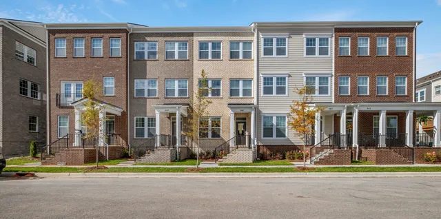 a front view of building with yard and traffic signal