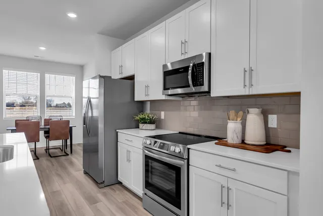 a kitchen with cabinets and stainless steel appliances