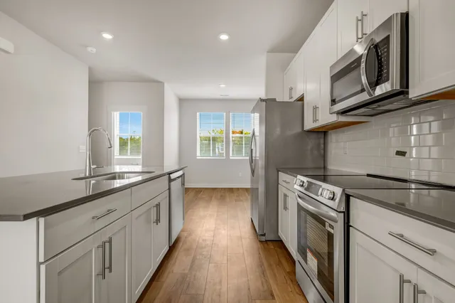 a kitchen with a stove and a microwave