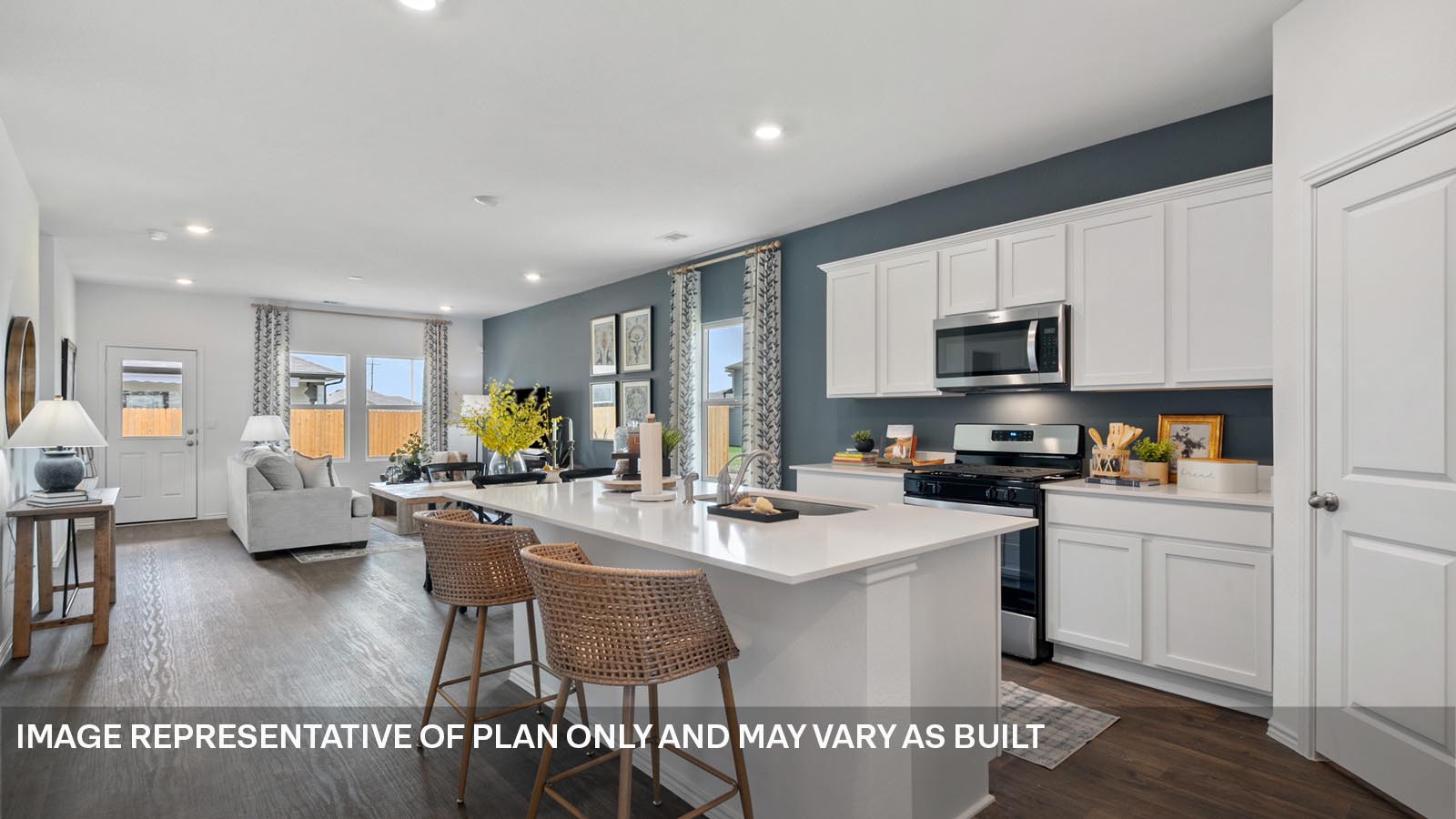 174 Balmorhea Street Kyle, TX 78640 - Photo 4 of 27 a open kitchen with stainless steel appliances kitchen island granite countertop a stove a sink a dining table and chairs