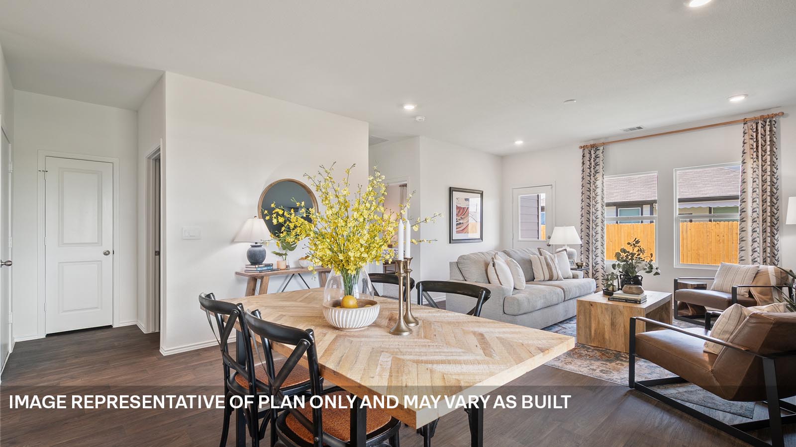 174 Balmorhea Street Kyle, TX 78640 - Photo 7 of 27 a living room with furniture a chandelier and a table