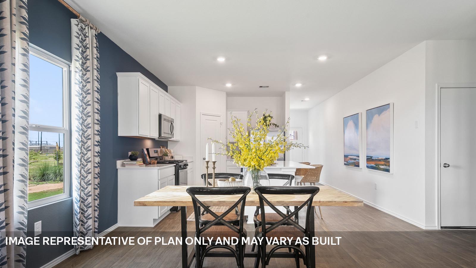 174 Balmorhea Street Kyle, TX 78640 - Photo 8 of 27 a dining room with furniture and a wooden floor