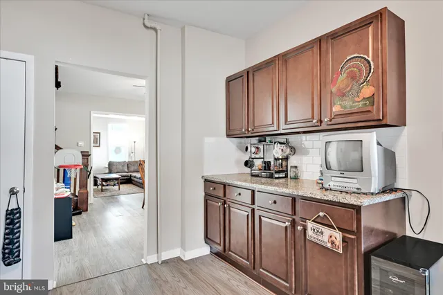 a kitchen with stainless steel appliances granite countertop a stove top oven a sink dishwasher and cabinets with wooden floor