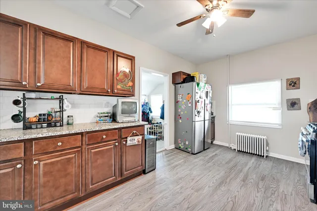 a kitchen with refrigerator and window