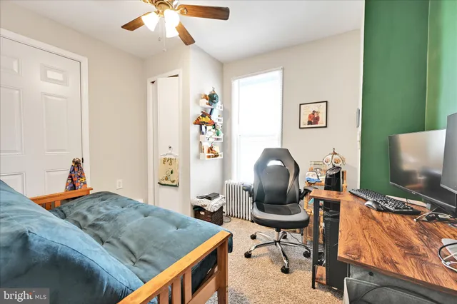 a bedroom with furniture and a flat screen tv