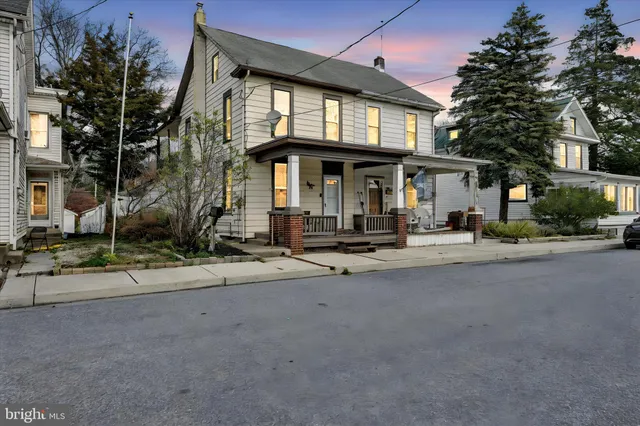 a front view of a house with a street