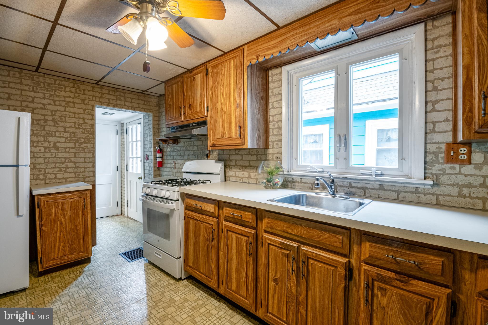 420 North 11th Street Reading, PA 19604 - Photo 8 of 20 a kitchen with sink a oven and wooden cabinets