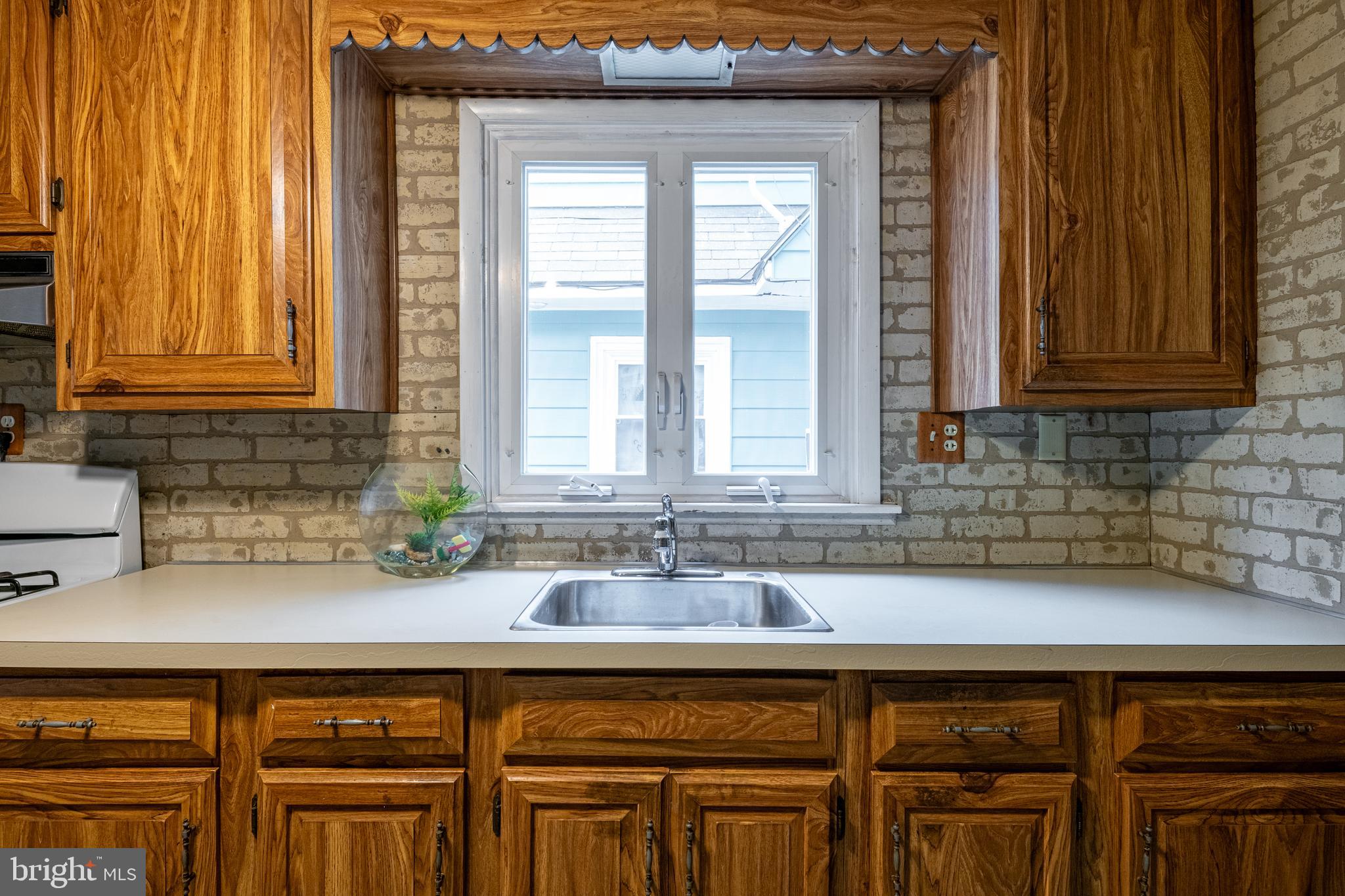 420 North 11th Street Reading, PA 19604 - Photo 10 of 20 a kitchen with stainless steel appliances granite countertop a sink and a window
