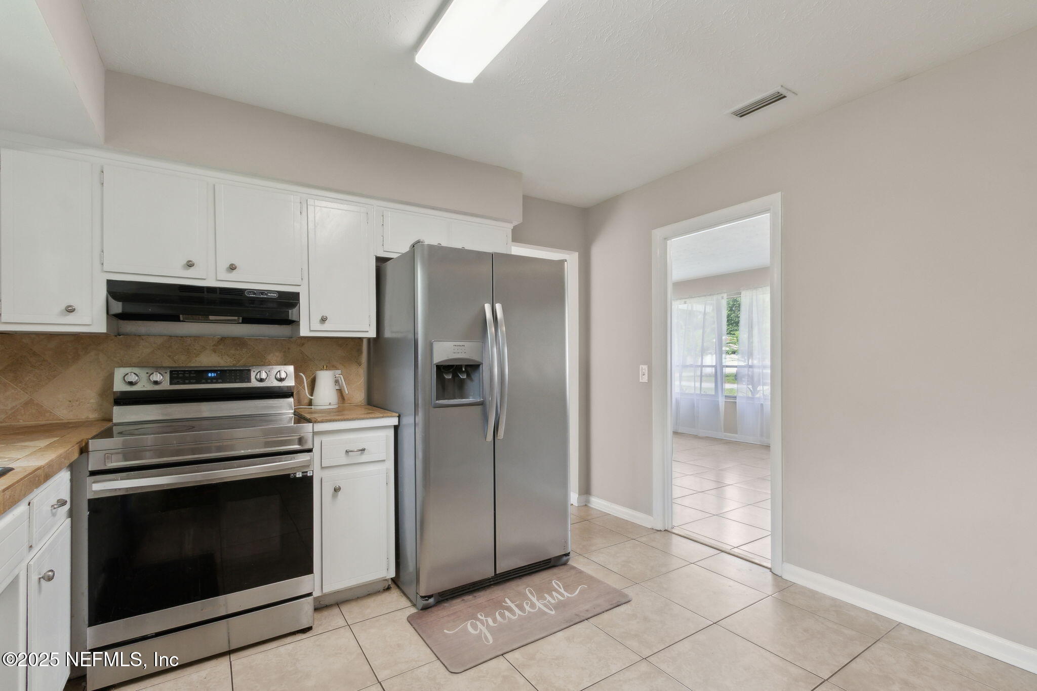 2806 Annette Circle Jacksonville, FL 32216 - Photo 13 of 31 a kitchen with a stove top oven and refrigerator
