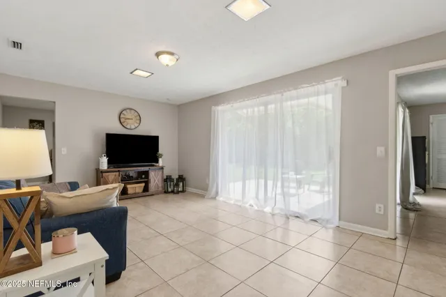 a view of a livingroom with workspace and a window