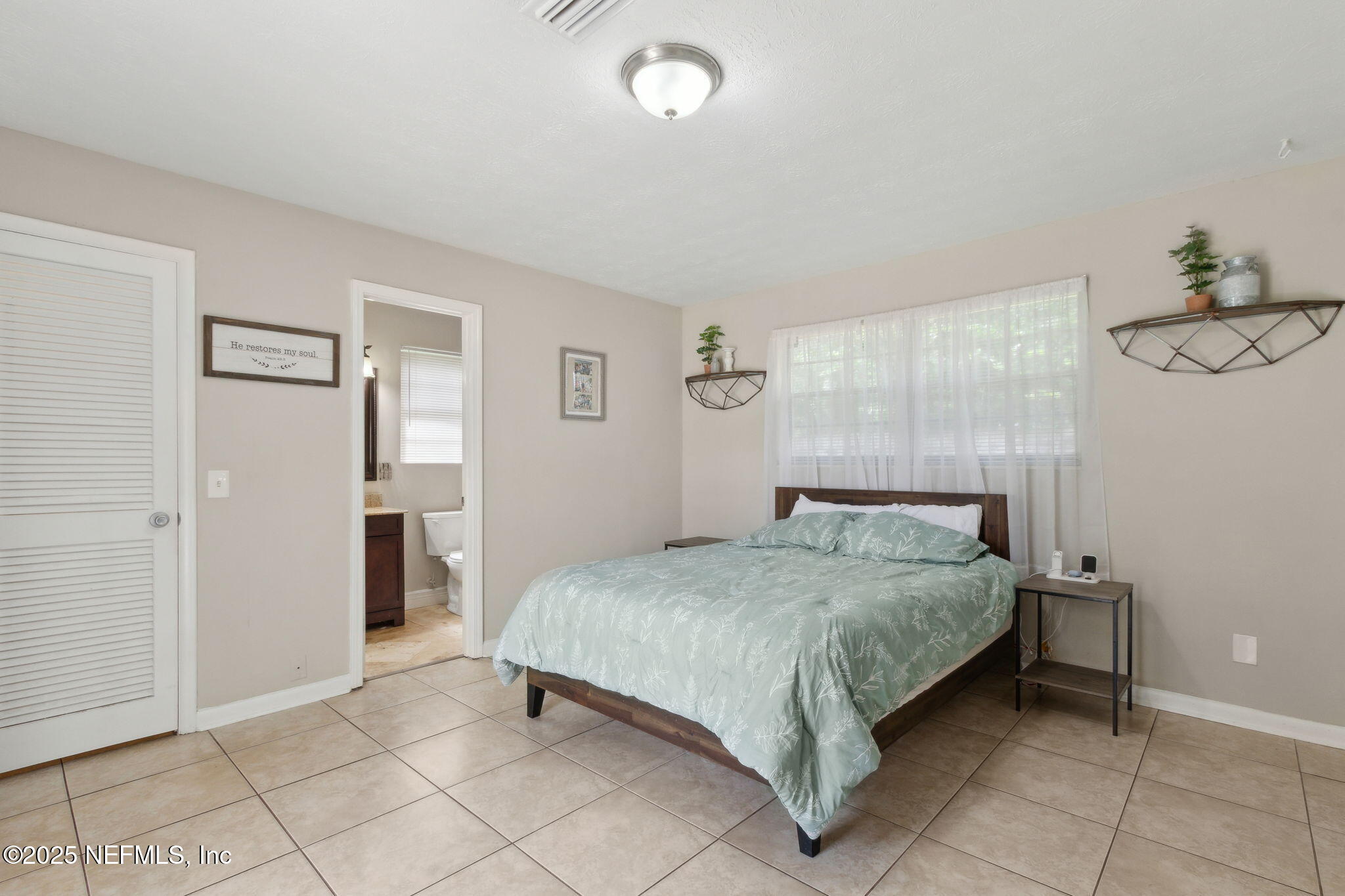 2806 Annette Circle Jacksonville, FL 32216 - Photo 18 of 31 a bedroom with a bed and cabinets