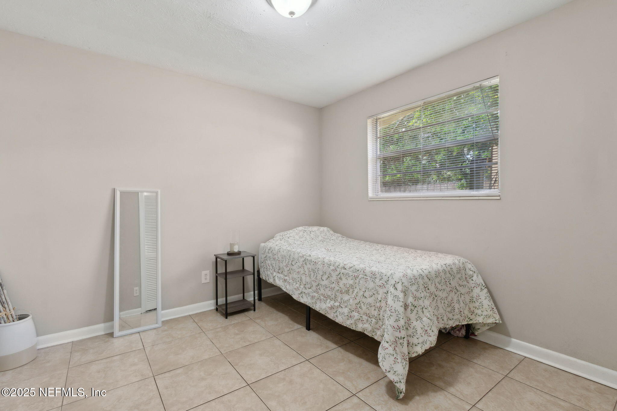2806 Annette Circle Jacksonville, FL 32216 - Photo 25 of 31 a bed sitting in a bedroom next to a window