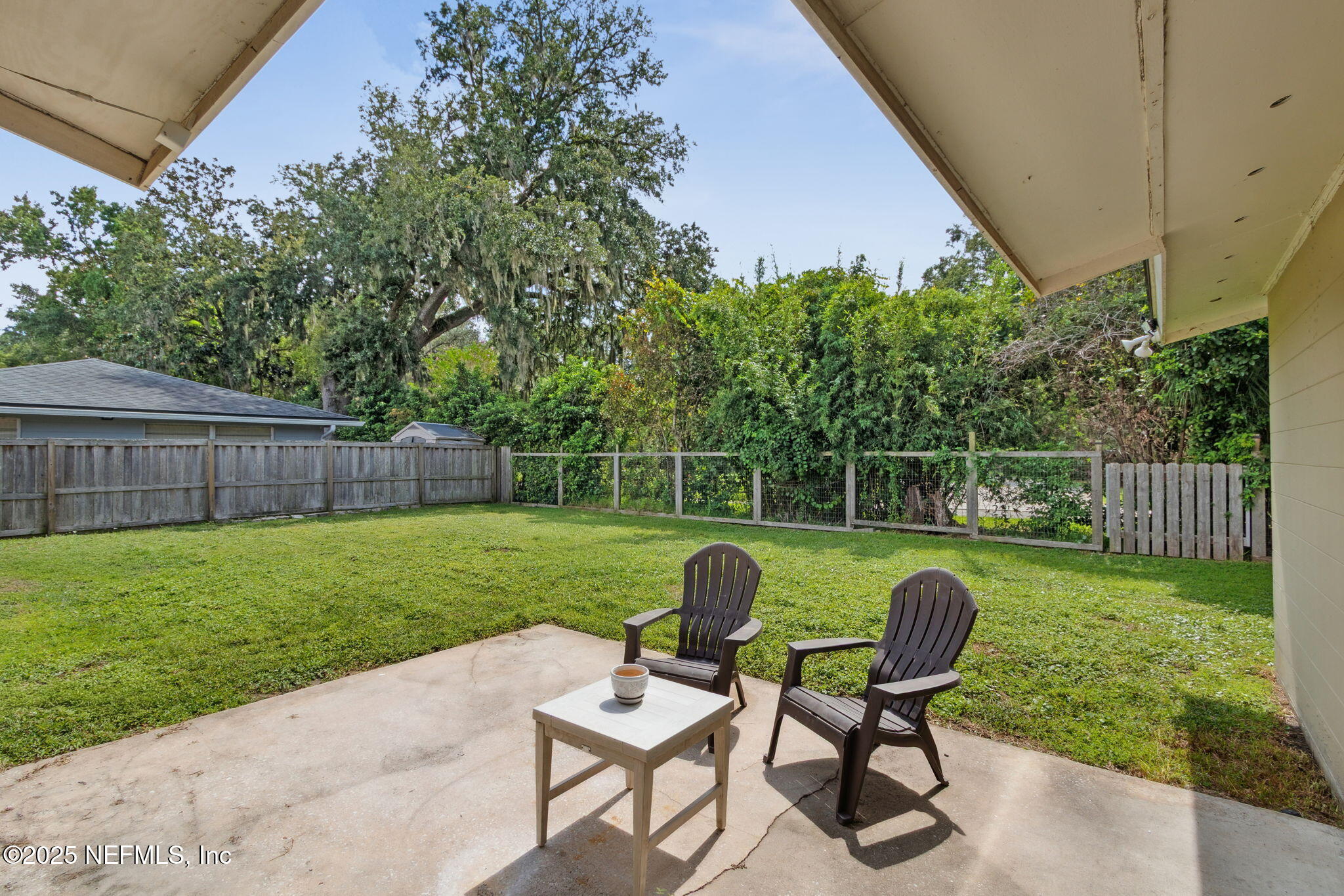 2806 Annette Circle Jacksonville, FL 32216 - Photo 28 of 31 a view of a chair and table in the back yard of the house