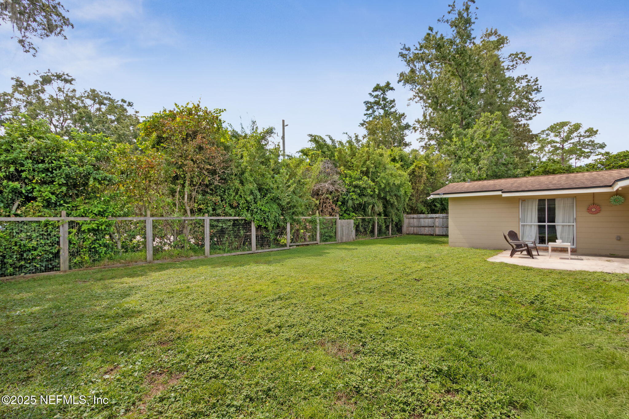 2806 Annette Circle Jacksonville, FL 32216 - Photo 30 of 31 a backyard of a house with table and chairs