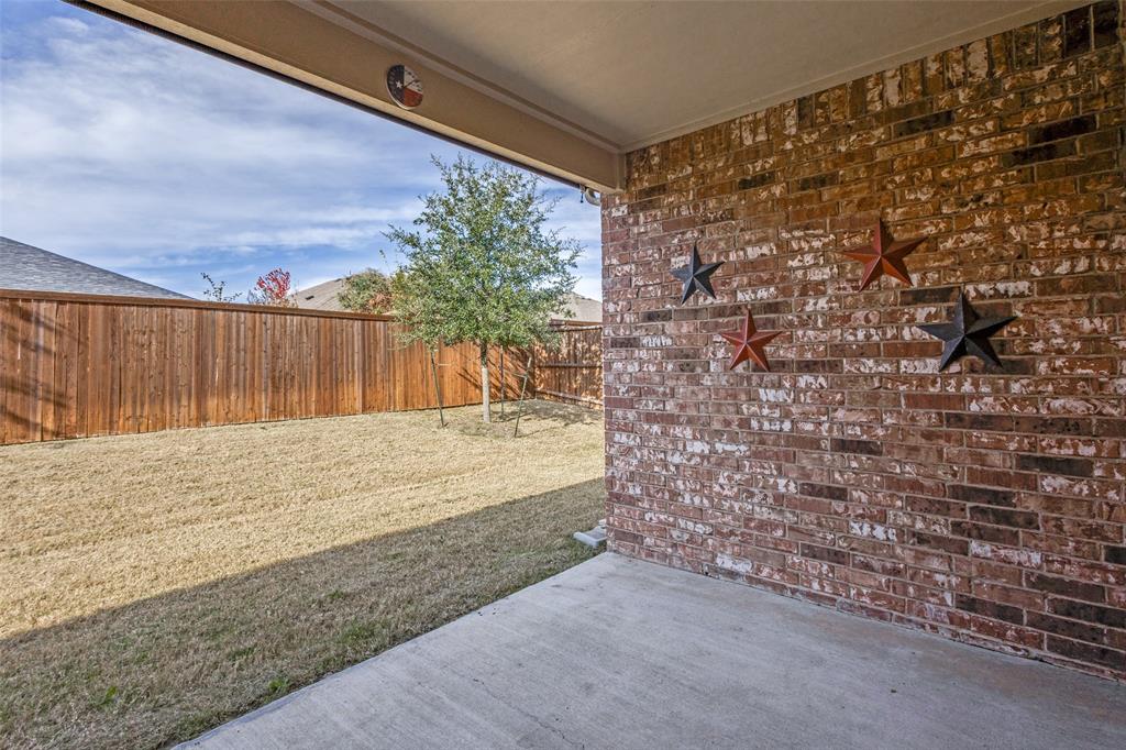 1810 Hummingbird Street Princeton, TX 75407 - Photo 23 of 25 The covered patio offers a secluded retreat for both relaxation with your favorite cup of morning coffee and unwinding amid the tranquil sounds of nature in the evenings. For additional privacy pull-down the sun shade. For those who have a four-legged member of the family, this is a tail wagging place to live!