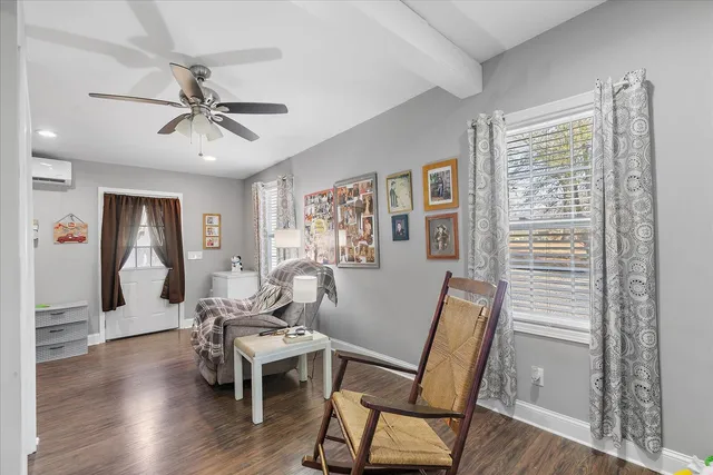 a bedroom with furniture and flat screen tv