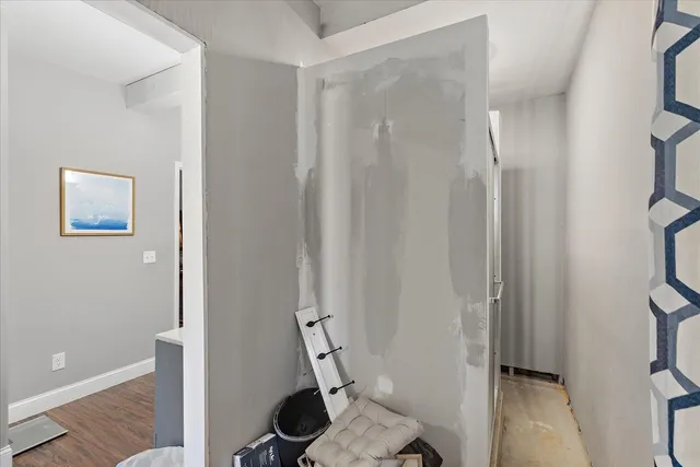 a spacious bedroom with a bed and a chandelier