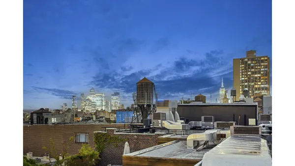a view of roof deck with patio and outdoor seating