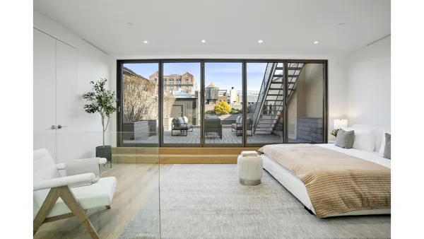 a living room with furniture and a painting