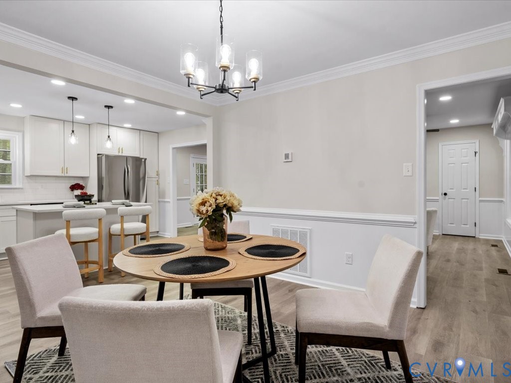 12130 Quito Road Midlothian, VA 23112 - Photo 17 of 41 a view of a dining room with furniture and chandelier