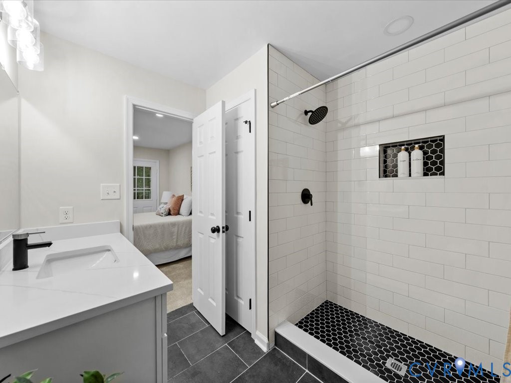12130 Quito Road Midlothian, VA 23112 - Photo 23 of 41 a bathroom with a sink a toilet and shower