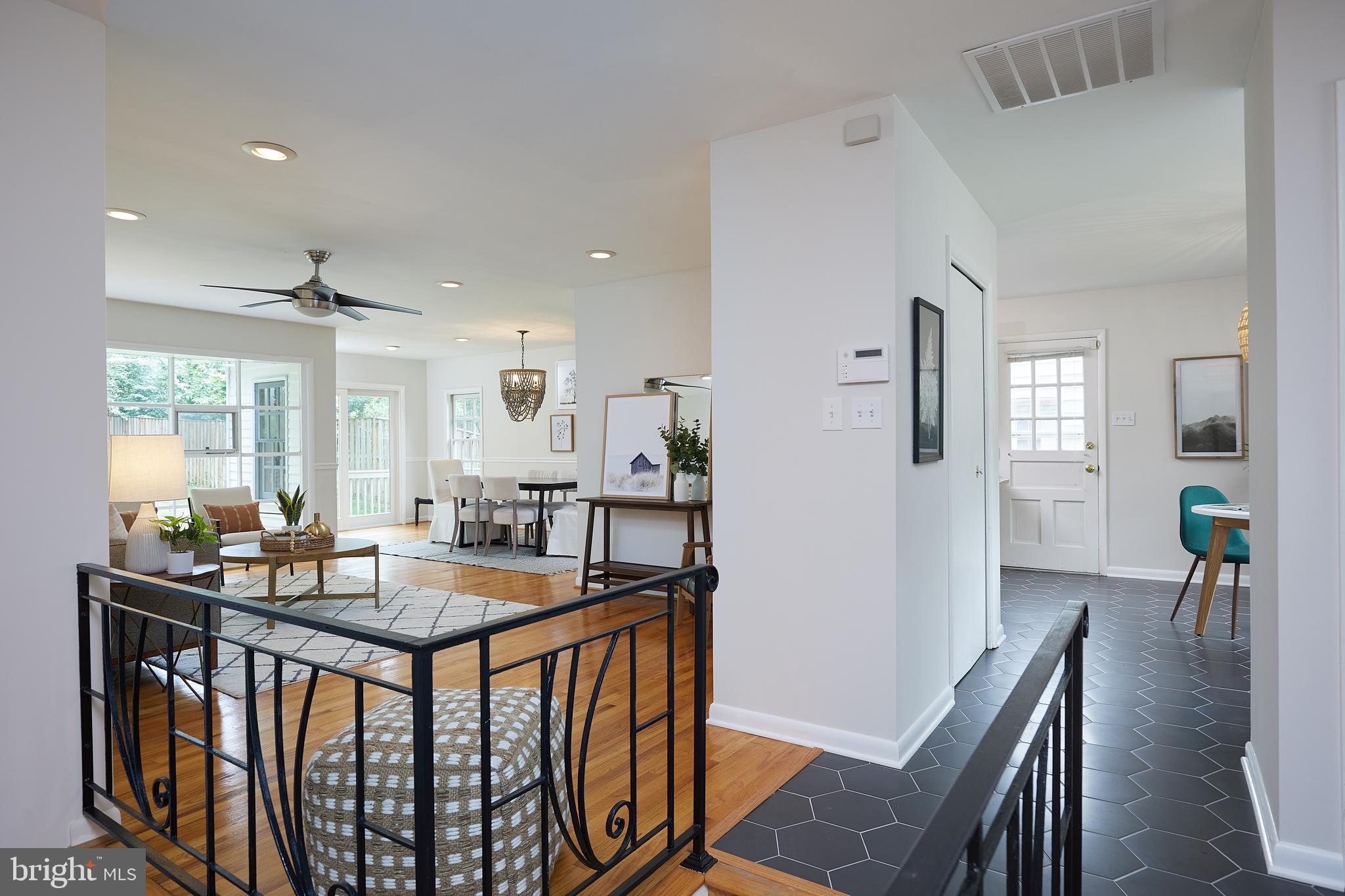 10611 Glenwild Road Silver Spring, MD 20901 - Photo 9 of 39 a dining hall with stainless steel appliances granite countertop a table chairs and a refrigerator