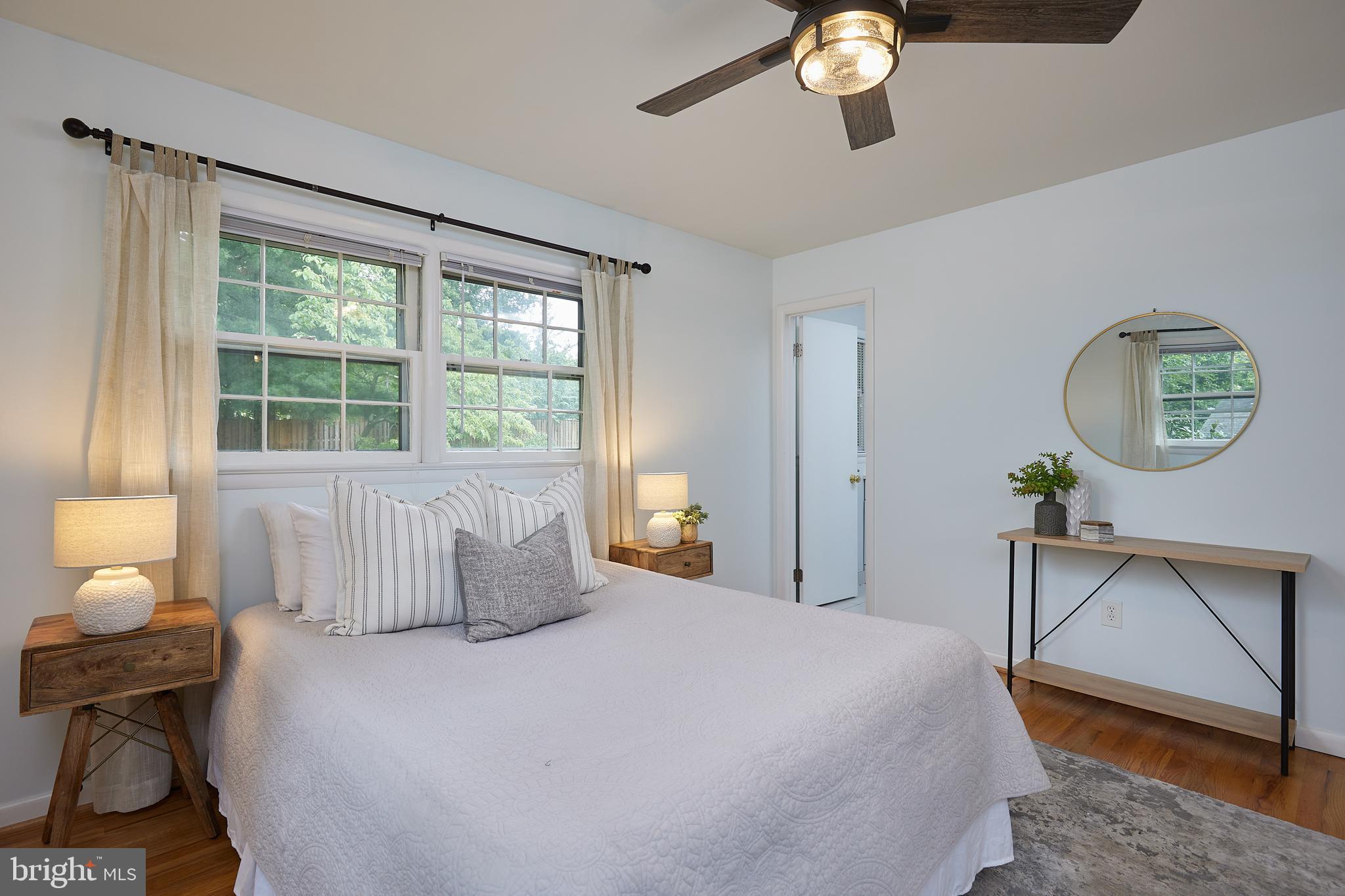 10611 Glenwild Road Silver Spring, MD 20901 - Photo 17 of 39 a bedroom with a bed a chandelier and a window