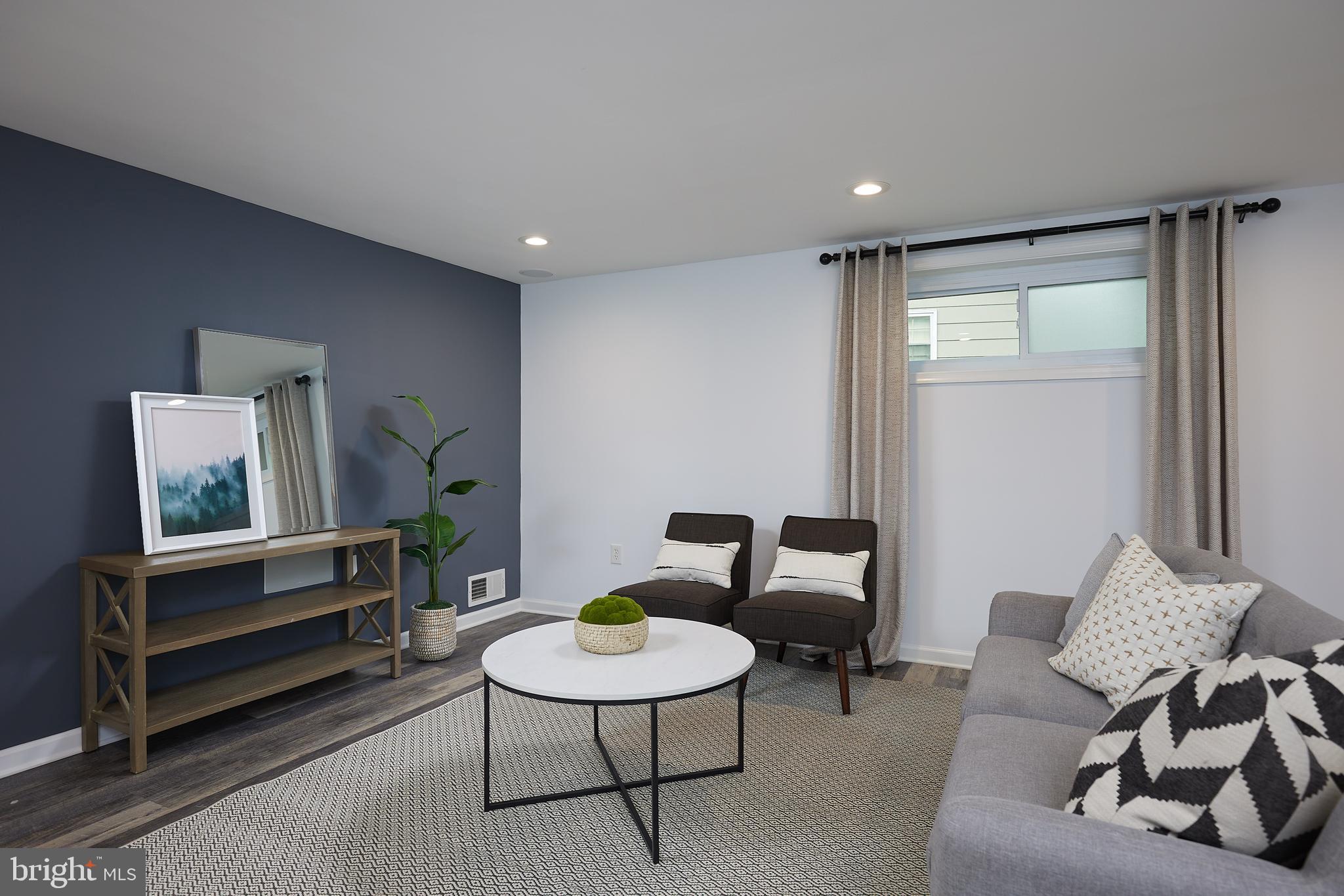 10611 Glenwild Road Silver Spring, MD 20901 - Photo 27 of 39 a living room with furniture and a rug