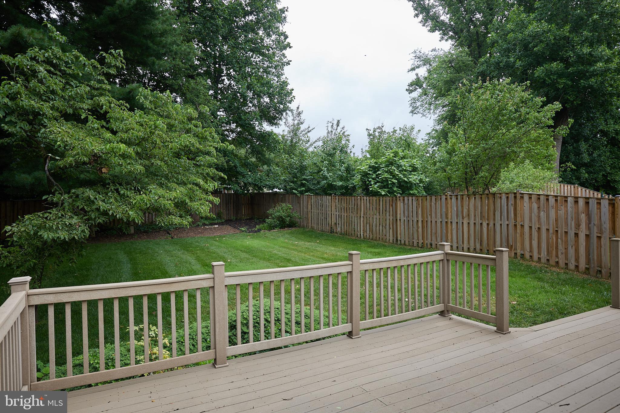 10611 Glenwild Road Silver Spring, MD 20901 - Photo 32 of 39 a wooden deck with trees in the background
